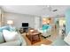 Open living room with coastal decor and view to dining area at 555 Circlewood Dr # T10, Venice, FL 34293