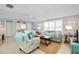 Spacious living room featuring light teal sofas and coastal decor at 555 Circlewood Dr # T10, Venice, FL 34293