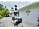 Small patio with bistro set and umbrella, adjacent to the house at 555 Circlewood Dr # T10, Venice, FL 34293