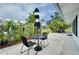 Relaxing patio with bistro set and umbrella, near the house at 555 Circlewood Dr # T10, Venice, FL 34293