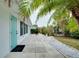 Side yard with patio, landscaping, and access to the backyard at 555 Circlewood Dr # T10, Venice, FL 34293