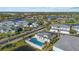 Aerial view of community with lake, pool, and many homes at 5766 Sabal Trace Dr # 3B5766, North Port, FL 34287