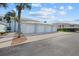 Another side view of the condo building highlighting the garages and landscaping at 5766 Sabal Trace Dr # 3B5766, North Port, FL 34287