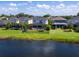 Aerial view showcasing a house near a lake with a pool at 5930 Anise Dr, Sarasota, FL 34238