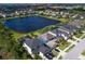 Aerial view of house and neighborhood with lake in background at 5930 Anise Dr, Sarasota, FL 34238