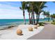 Scenic walkway along the beach with palm trees at 5930 Anise Dr, Sarasota, FL 34238