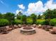 Stone fire pit with comfortable seating in a landscaped area at 5930 Anise Dr, Sarasota, FL 34238