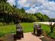 Two built-in grills in a grassy area with a brick patio at 5930 Anise Dr, Sarasota, FL 34238