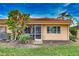 Rear view of home showcasing the patio and yard at 601 Tyson Ter # 1, Venice, FL 34285