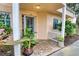 Inviting front entrance with lush landscaping and a charming white picket fence at 601 Tyson Ter # 1, Venice, FL 34285