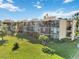 Aerial view of condo building with lush landscaping at 612 Bird Bay S Dr # 309, Venice, FL 34285