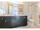 Bathroom with dark vanity, shower, and toilet at 612 Bird Bay S Dr # 309, Venice, FL 34285