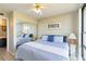 Bright bedroom with a queen-size bed and mirrored closet at 612 Bird Bay S Dr # 309, Venice, FL 34285