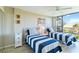 Bright bedroom with twin beds, offering ample natural light and a peaceful atmosphere at 612 Bird Bay S Dr # 309, Venice, FL 34285