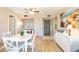 Bright dining room with white table and chairs at 612 Bird Bay S Dr # 309, Venice, FL 34285