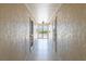 Clean and well-lit hallway with access to outdoor balcony at 612 Bird Bay S Dr # 309, Venice, FL 34285
