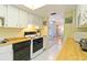 Updated kitchen with white cabinets, wood countertops, and a view into the dining area at 612 Bird Bay S Dr # 309, Venice, FL 34285