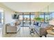 Living room with patio access, neutral decor, and modern furnishings at 612 Bird Bay S Dr # 309, Venice, FL 34285