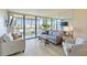 Living room with balcony access and relaxing seating area at 612 Bird Bay S Dr # 309, Venice, FL 34285