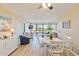 Open living space featuring a dining table, seating area, and balcony access at 612 Bird Bay S Dr # 309, Venice, FL 34285
