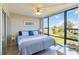 Spacious bedroom with large windows, comfortable bed, and serene views at 612 Bird Bay S Dr # 309, Venice, FL 34285