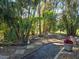 Landscaped backyard with stone path and tropical plants at 624 Silk Oak Dr, Venice, FL 34293