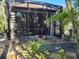 Screened patio with lush tropical landscaping at 624 Silk Oak Dr, Venice, FL 34293