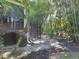 Landscaped backyard with screened patio and lush vegetation at 624 Silk Oak Dr, Venice, FL 34293