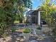 Relaxing backyard oasis with a screened patio and lush tropical landscaping at 624 Silk Oak Dr, Venice, FL 34293