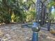 Landscaped backyard with a spacious screened enclosure and a stone pathway at 624 Silk Oak Dr, Venice, FL 34293