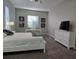 Bright bedroom with white dresser and a TV at 624 Silk Oak Dr, Venice, FL 34293