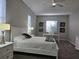 Spacious bedroom with a white bed frame and gray carpet at 624 Silk Oak Dr, Venice, FL 34293