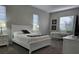 Bright bedroom with white furniture and gray carpeting at 624 Silk Oak Dr, Venice, FL 34293