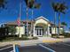 Community clubhouse with ample parking and welcoming entrance at 624 Silk Oak Dr, Venice, FL 34293