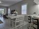 Bright dining area with white table and chairs near kitchen at 624 Silk Oak Dr, Venice, FL 34293