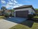 Single story home with a two car garage, driveway and landscaping at 624 Silk Oak Dr, Venice, FL 34293