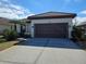 Single-story home with a two-car garage and attractive landscaping at 624 Silk Oak Dr, Venice, FL 34293