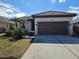 Single-story house with brown garage door and manicured lawn at 624 Silk Oak Dr, Venice, FL 34293