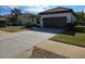 Single story home with a two-car garage and manicured lawn at 624 Silk Oak Dr, Venice, FL 34293
