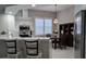 Bright kitchen with white cabinets, quartz countertops, and breakfast bar at 624 Silk Oak Dr, Venice, FL 34293