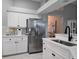 White kitchen features stainless steel appliances and quartz countertops at 624 Silk Oak Dr, Venice, FL 34293