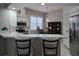 Bright kitchen with white cabinets, quartz countertops, and breakfast bar at 624 Silk Oak Dr, Venice, FL 34293