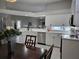 Modern kitchen features white cabinets, stainless steel appliances, and a large island at 624 Silk Oak Dr, Venice, FL 34293