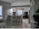 Bright kitchen with white cabinets, quartz countertops, and breakfast bar at 624 Silk Oak Dr, Venice, FL 34293