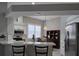 Bright kitchen with white cabinets, stainless steel appliances, and quartz countertops at 624 Silk Oak Dr, Venice, FL 34293