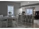 Kitchen features a breakfast bar and white cabinets at 624 Silk Oak Dr, Venice, FL 34293