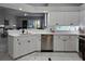 White shaker cabinets, stainless steel appliances, and quartz countertops in this kitchen at 624 Silk Oak Dr, Venice, FL 34293