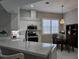 Updated kitchen with white cabinets, stainless steel appliances, and a quartz island at 624 Silk Oak Dr, Venice, FL 34293