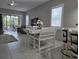 Living room with tile floors and view into dining area at 624 Silk Oak Dr, Venice, FL 34293