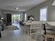 Open concept living room with gray sofas and access to backyard at 624 Silk Oak Dr, Venice, FL 34293